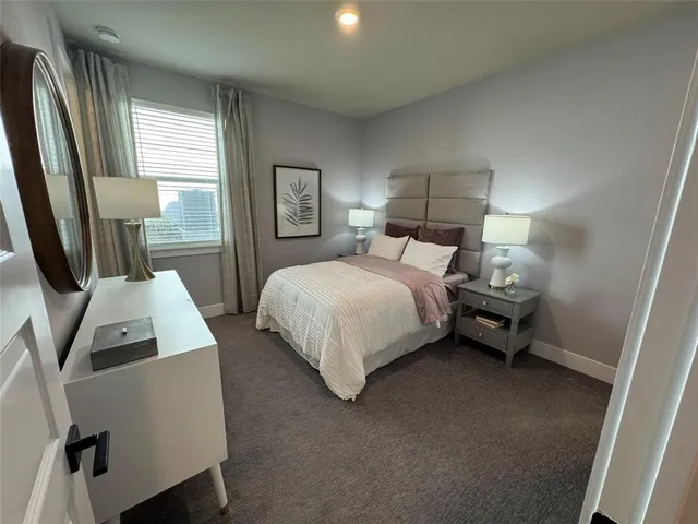 a bedroom with a bed and large mirror