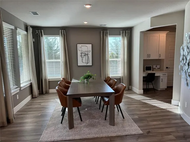 a view of a dining room with furniture window and wooden floor