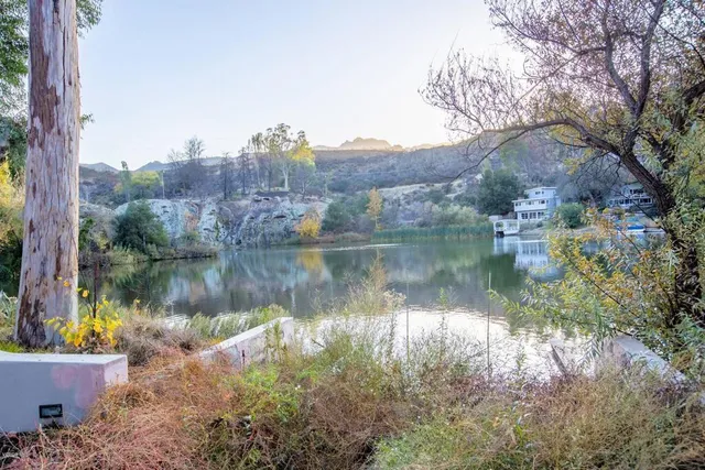 a view of a lake in middle of the forest