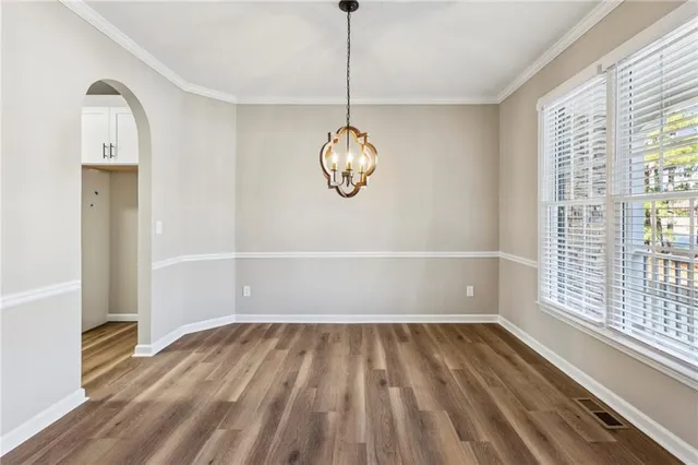 a view of a room with wooden floor and windows