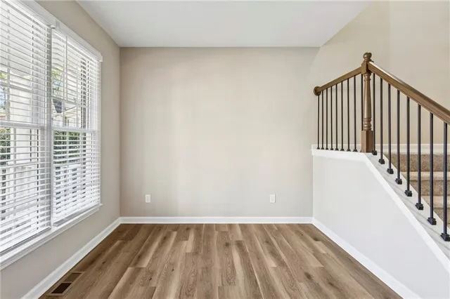 a view of an entryway with wooden floor and door