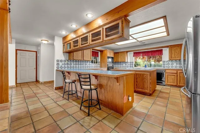 a kitchen with stainless steel appliances granite countertop a sink stove and cabinets
