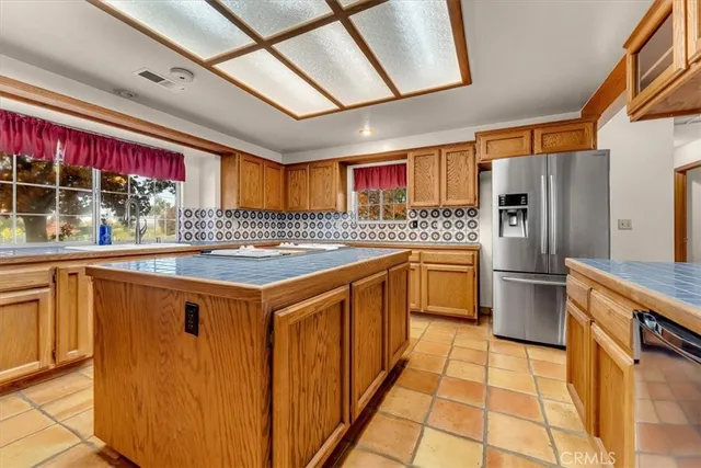 a kitchen with cabinets appliances and a counter top space