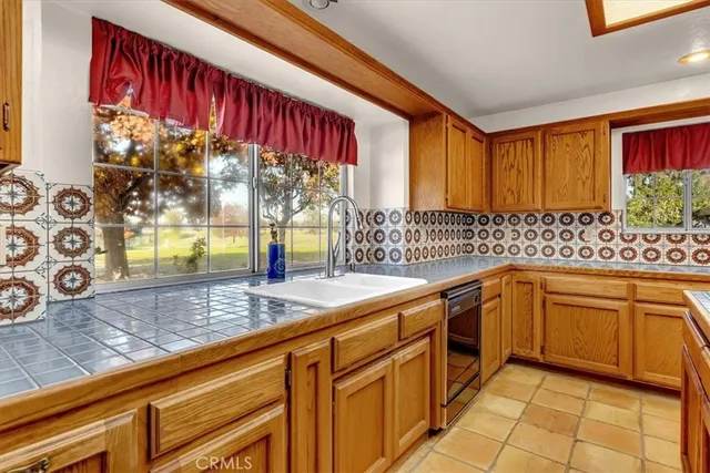 a kitchen with stainless steel appliances a stove sink and microwave