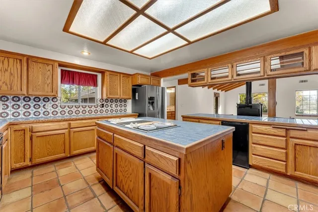 a kitchen with a stove top oven cabinets and a counter top space