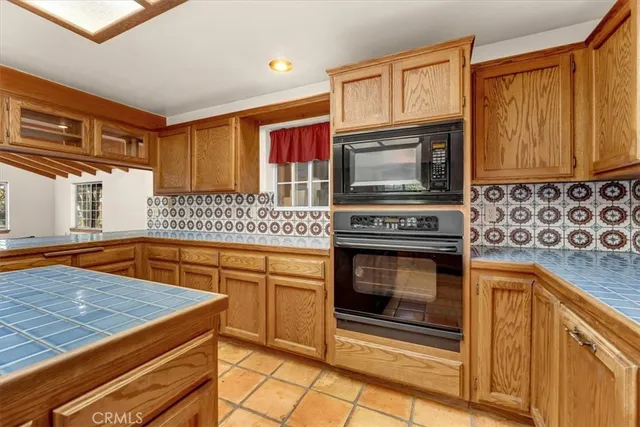 a view of a hallway with wooden floor and a next to a window