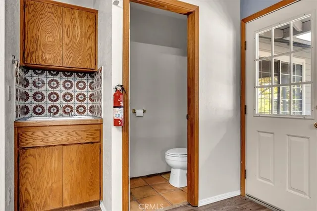 a view of swimming pool of water with lawn chairs and large tree