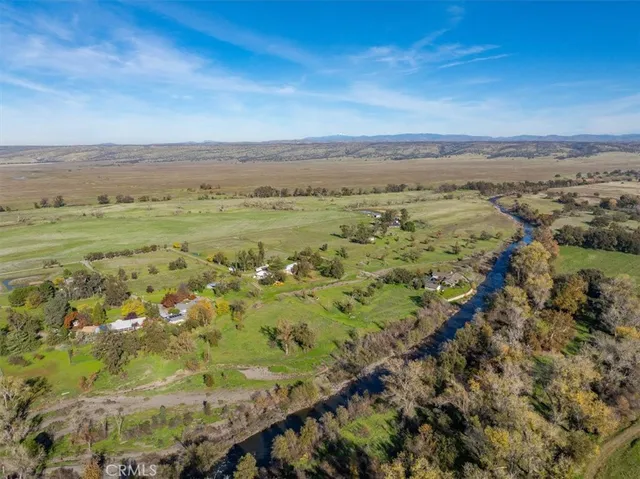 a view of a house with swimming pool and a yard