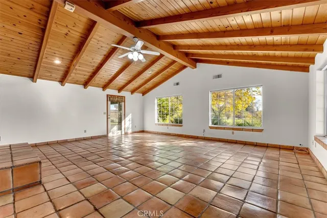 a kitchen with stainless steel appliances granite countertop a stove a refrigerator and a wooden cabinets