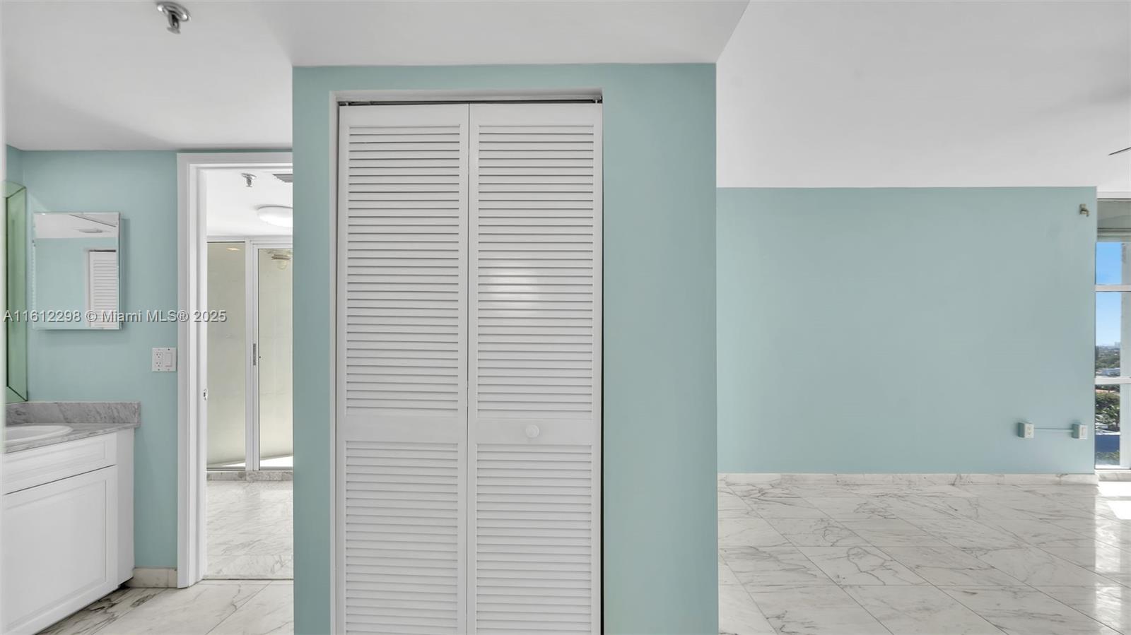 9341 Collins Avenue, Unit 707 Surfside, FL 33154 - Photo 12 of 55 a view of a bathroom with a sink