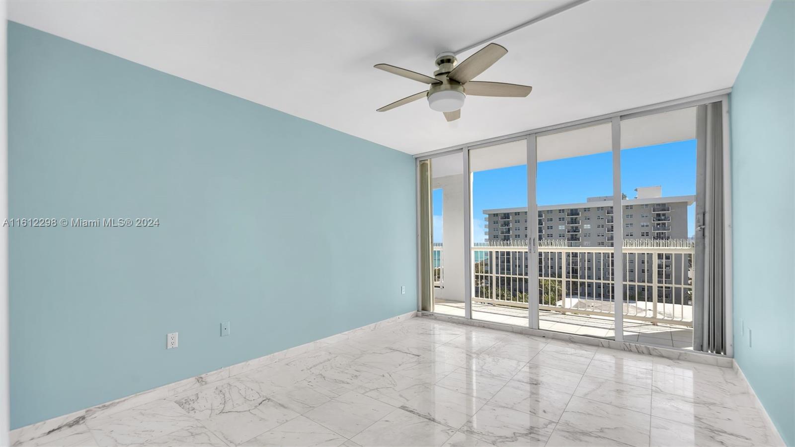 9341 Collins Avenue, Unit 707 Surfside, FL 33154 - Photo 15 of 55 a view of a livingroom with a ceiling fan and window