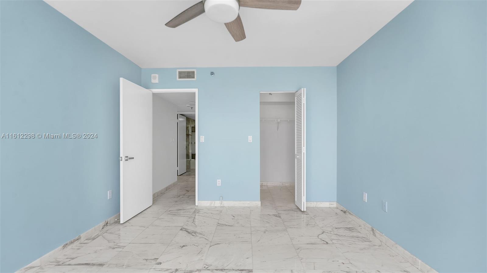 9341 Collins Avenue, Unit 707 Surfside, FL 33154 - Photo 18 of 55 an empty room with ceiling fan and window