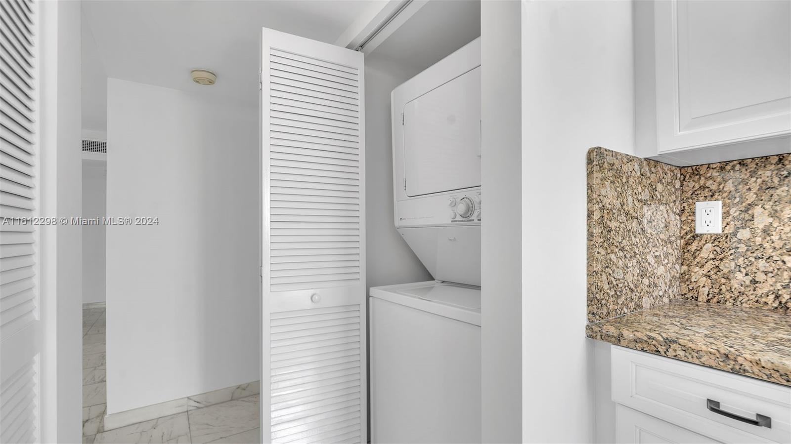 9341 Collins Avenue, Unit 707 Surfside, FL 33154 - Photo 21 of 55 a utility room with dryer and washer