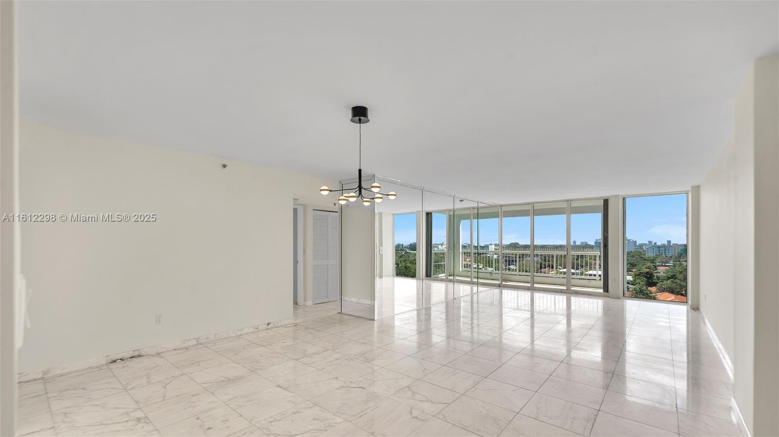 9341 Collins Avenue, Unit 707 Surfside, FL 33154 - Photo 4 of 55 a view of a room window and wooden floor