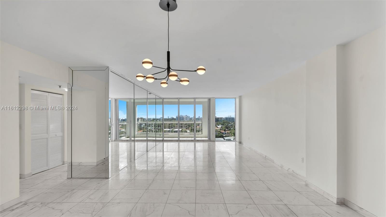 9341 Collins Avenue, Unit 707 Surfside, FL 33154 - Photo 7 of 55 a view of a livingroom with a chandelier furniture and windows