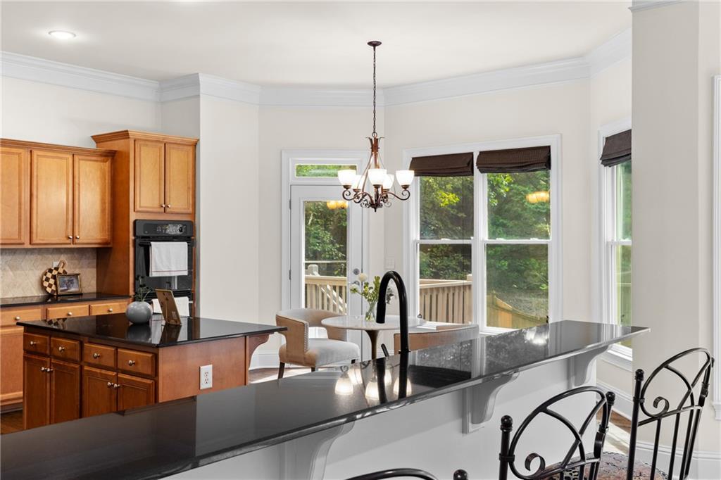 5765 Bailey Ridge Court Johns Creek, GA 30097 - Photo 11 of 51 a dining room with furniture a chandelier and large window