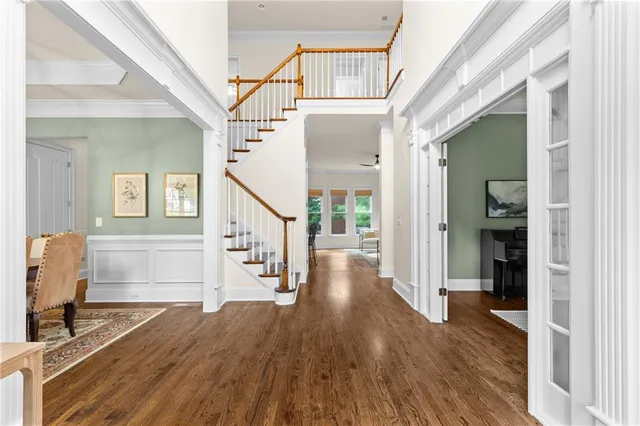 a view of entryway with wooden floor and stairs