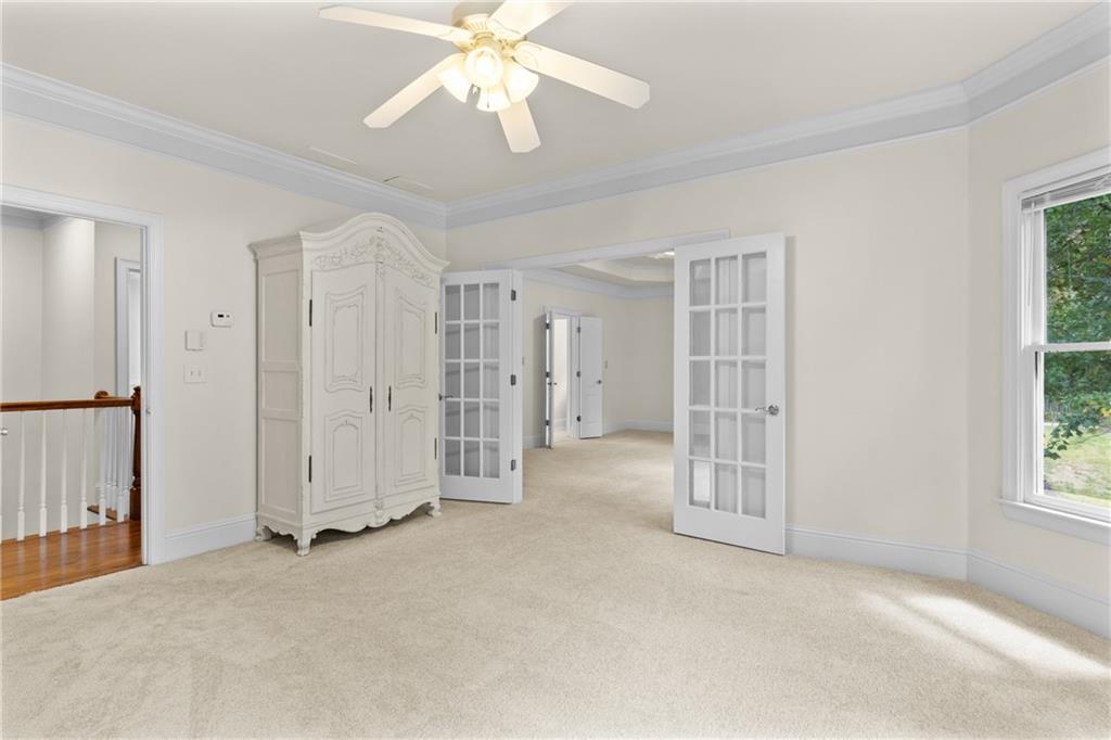5765 Bailey Ridge Court Johns Creek, GA 30097 - Photo 23 of 51 an empty room with a ceiling fan and a window