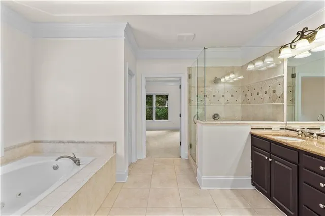 a bathroom with a tub sink and mirror