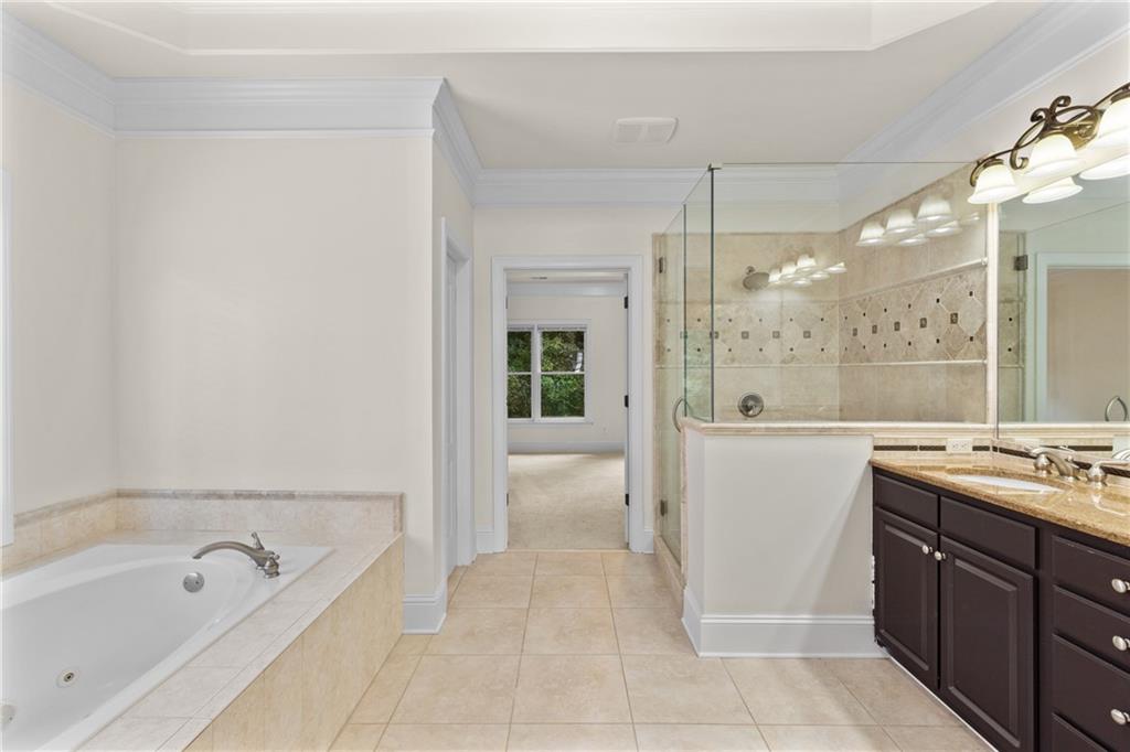 5765 Bailey Ridge Court Johns Creek, GA 30097 - Photo 27 of 51 a bathroom with a tub sink and mirror
