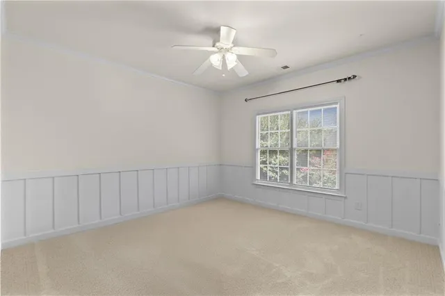 an empty room with fan and entrance