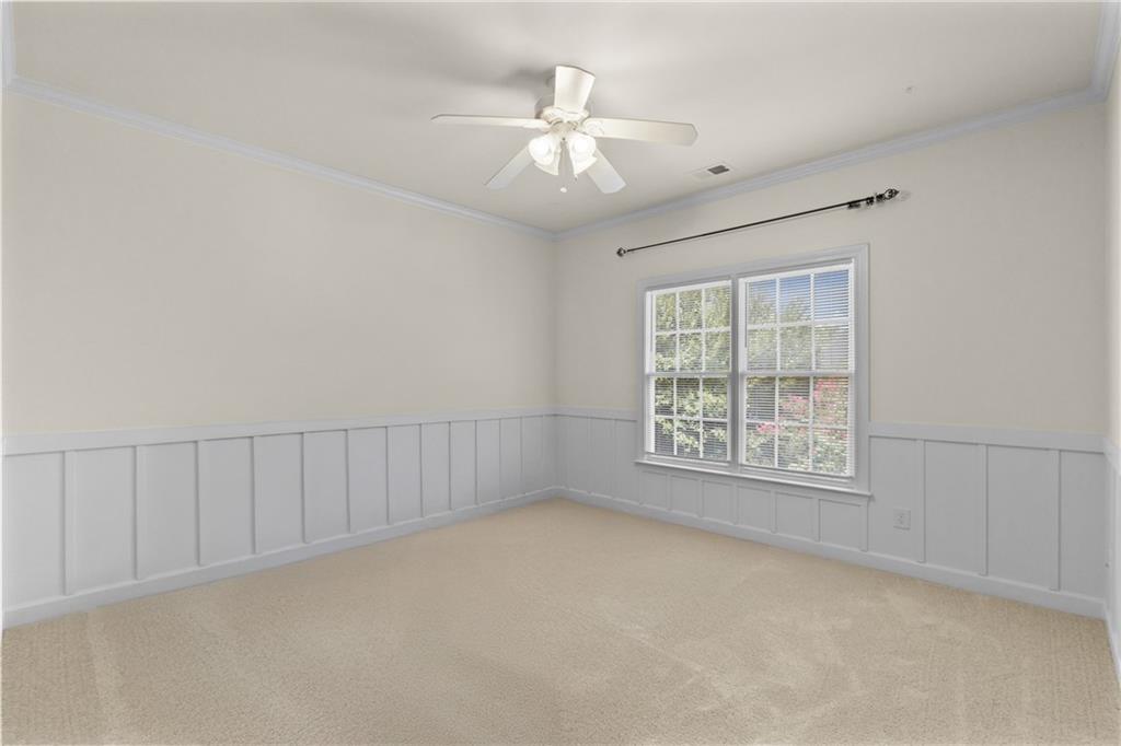 5765 Bailey Ridge Court Johns Creek, GA 30097 - Photo 32 of 51 an empty room with chandelier fan and windows