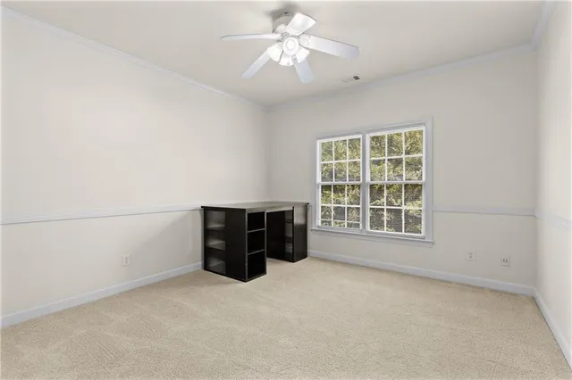 a view of an empty room with cabinet and chandelier fan