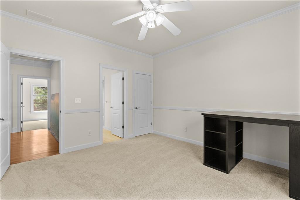 5765 Bailey Ridge Court Johns Creek, GA 30097 - Photo 36 of 51 a view of an empty room with cabinet and chandelier fan