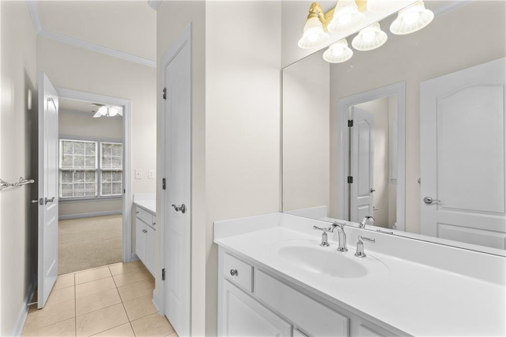 5765 Bailey Ridge Court Johns Creek, GA 30097 - Photo 37 of 51 a bathroom with a sink vanity granite and a mirror