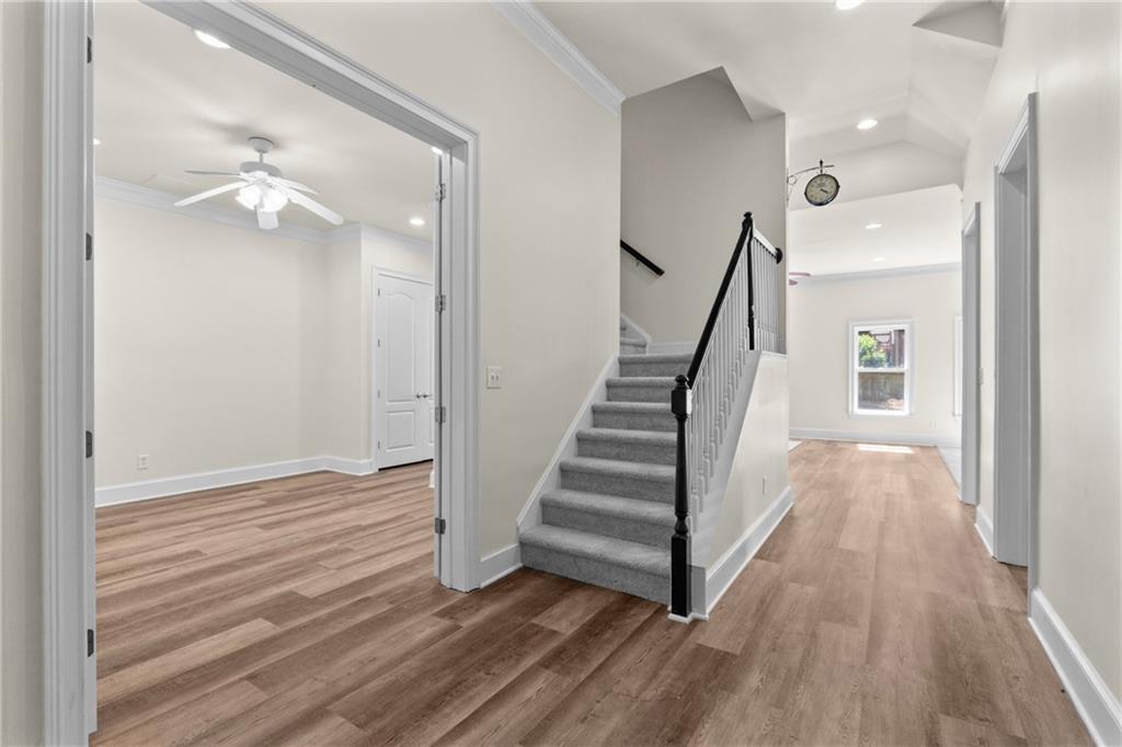 5765 Bailey Ridge Court Johns Creek, GA 30097 - Photo 39 of 51 a view of a hallway with wooden floor and staircase