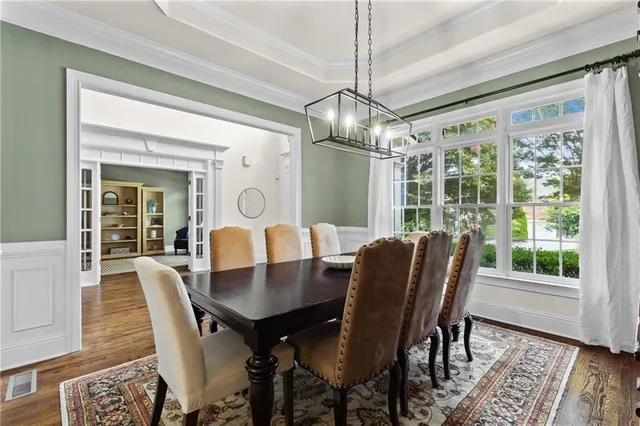 a view of a dining room with furniture window and wooden floor
