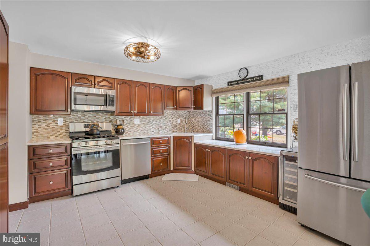 32 Millbridge Road Clementon, NJ 08021 - Photo 3 of 21 a kitchen with stainless steel appliances granite countertop a refrigerator sink and wooden cabinets