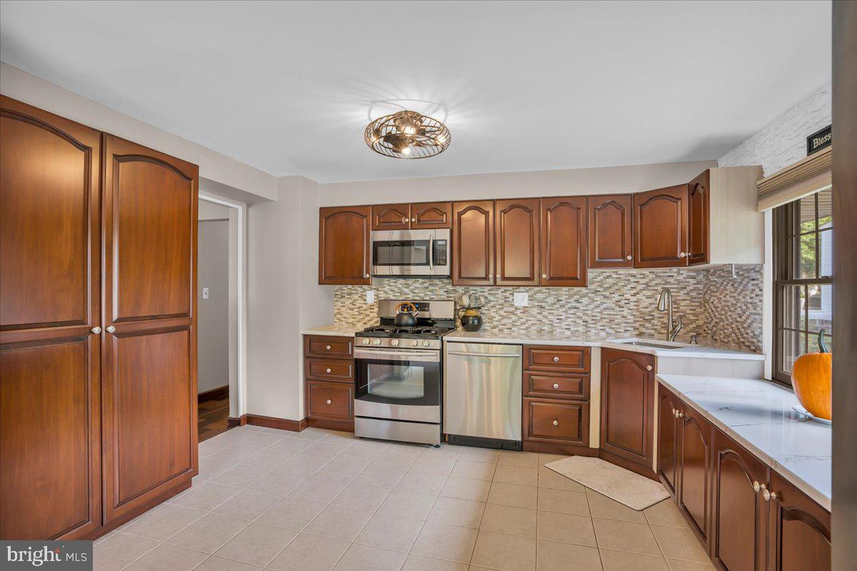 32 Millbridge Road Clementon, NJ 08021 - Photo 7 of 21 a kitchen with stainless steel appliances granite countertop a refrigerator and a stove top oven