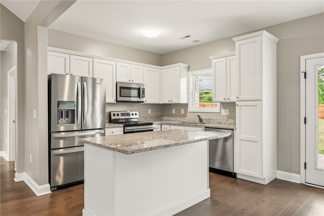 1411 Dunn Road Anderson, SC 29625 - Photo 11 of 30 This modern kitchen features gleaming stainless steel appliances, abundant cabinetry, and a central island.