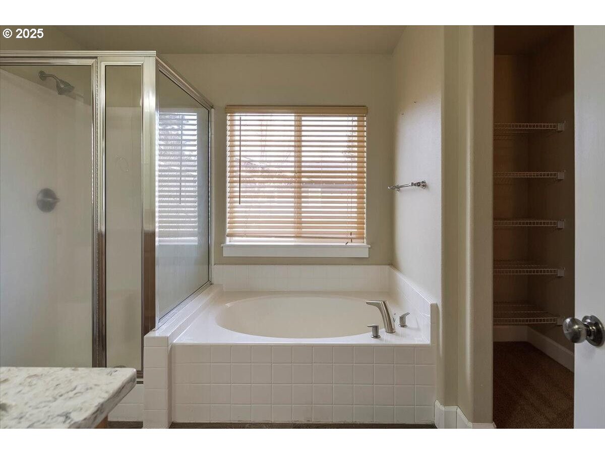 20370 Murphy Road Bend, OR 97702 - Photo 18 of 30 a bathroom with a bathtub and a shower