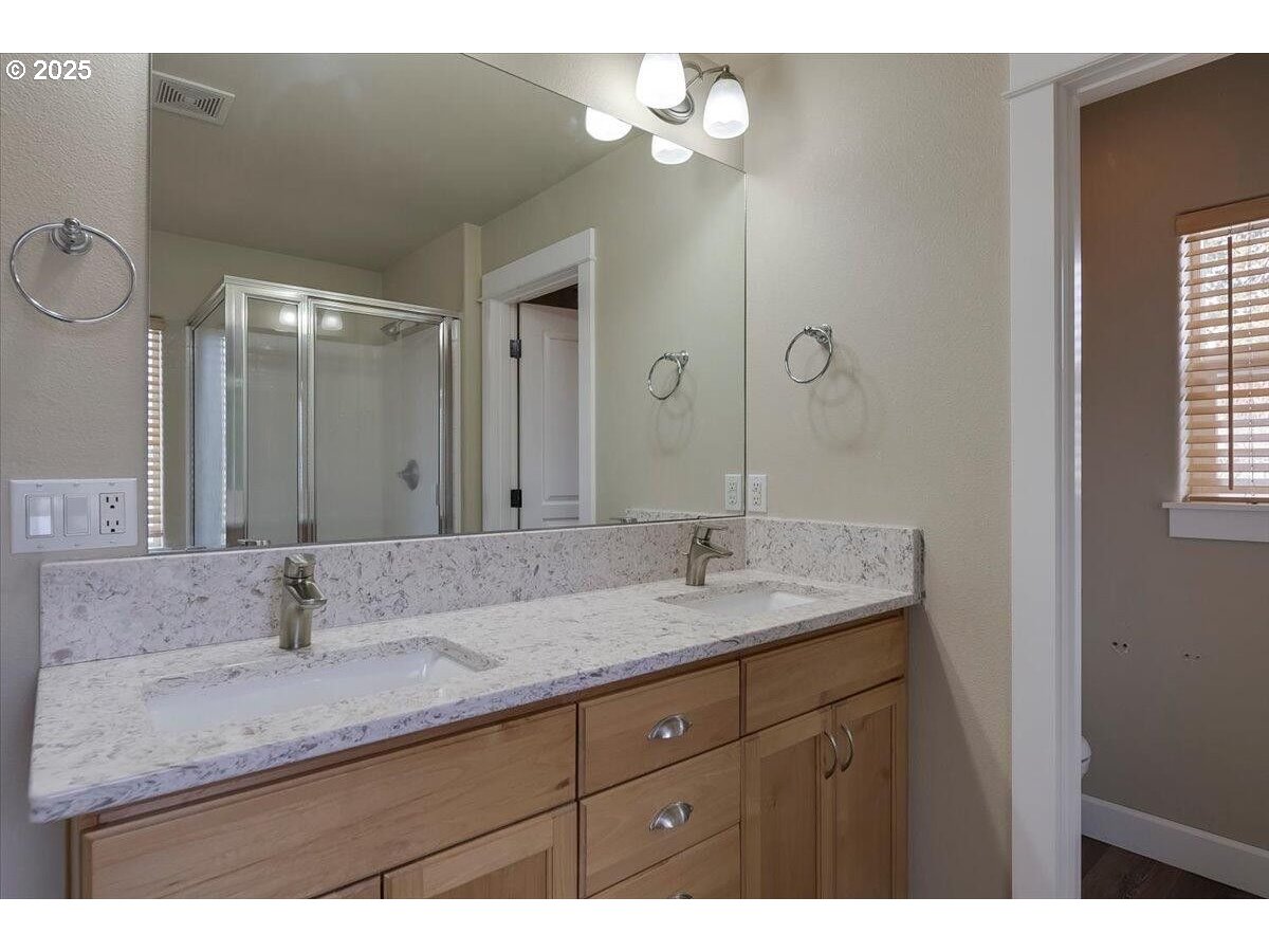 20370 Murphy Road Bend, OR 97702 - Photo 19 of 30 a bathroom with a granite countertop sink and a mirror