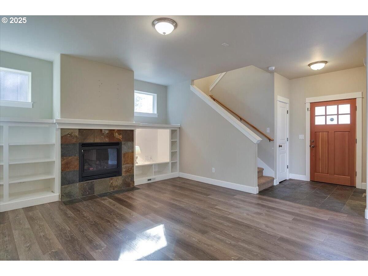 20370 Murphy Road Bend, OR 97702 - Photo 3 of 30 a view of an empty room with wooden floor fireplace and a window