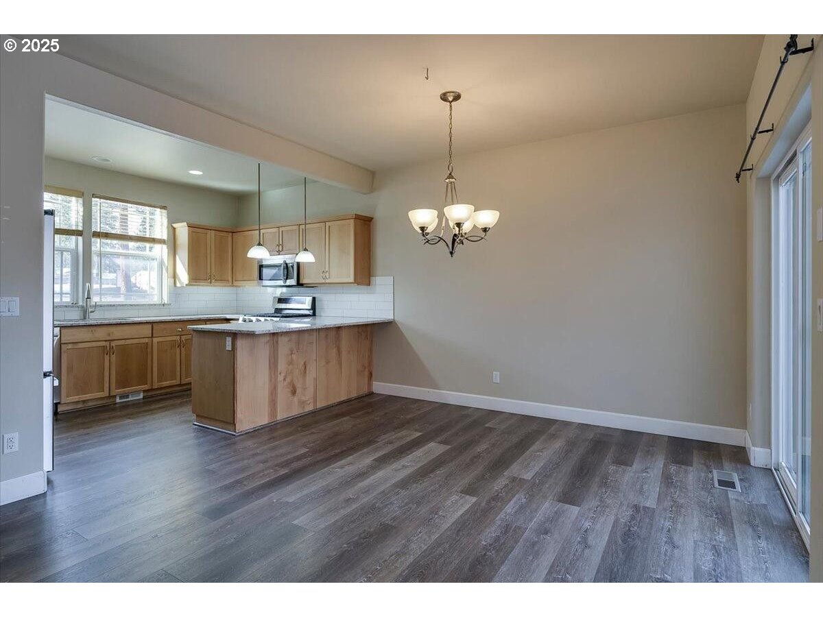 20370 Murphy Road Bend, OR 97702 - Photo 5 of 30 a view of a kitchen counter space a sink wooden floor and kitchen view