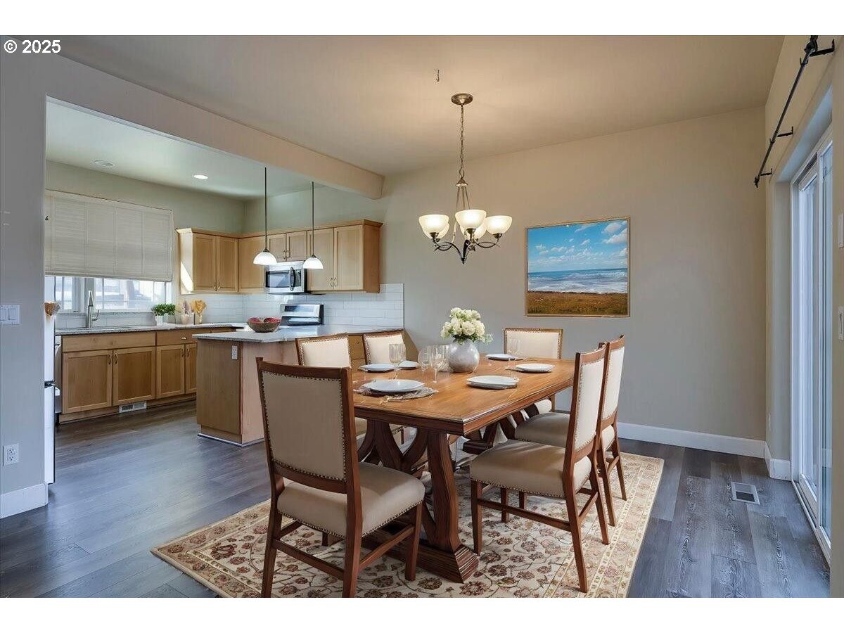 20370 Murphy Road Bend, OR 97702 - Photo 6 of 30 a view of a dining room with furniture and wooden floor