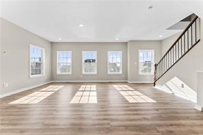 1293 Bedford Road, Unit 2086A Irwin, PA 15642 - Photo 3 of 8 a view of an empty room with wooden floor and a window