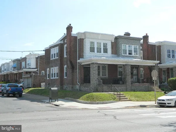 a view of a brick building next to a yard