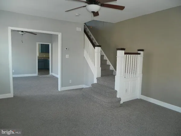 a view of an empty room with stairs