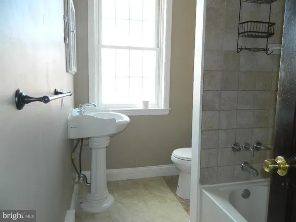 a bathroom with a sink a toilet and bathtub