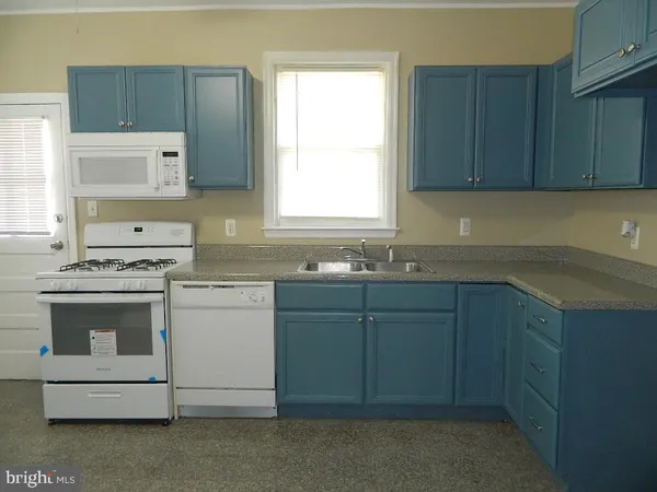 a kitchen with sink cabinets and window