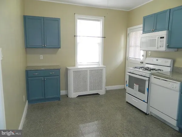 a kitchen with stainless steel appliances granite countertop a stove and a refrigerator