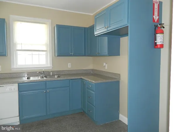 a kitchen with sink cabinets and window