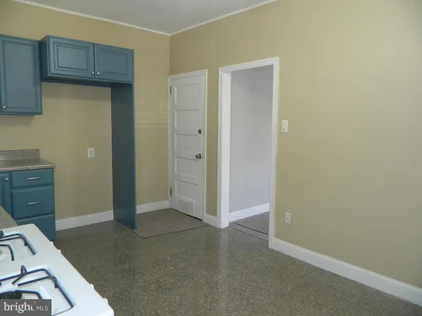 an empty room with closet and wooden floor