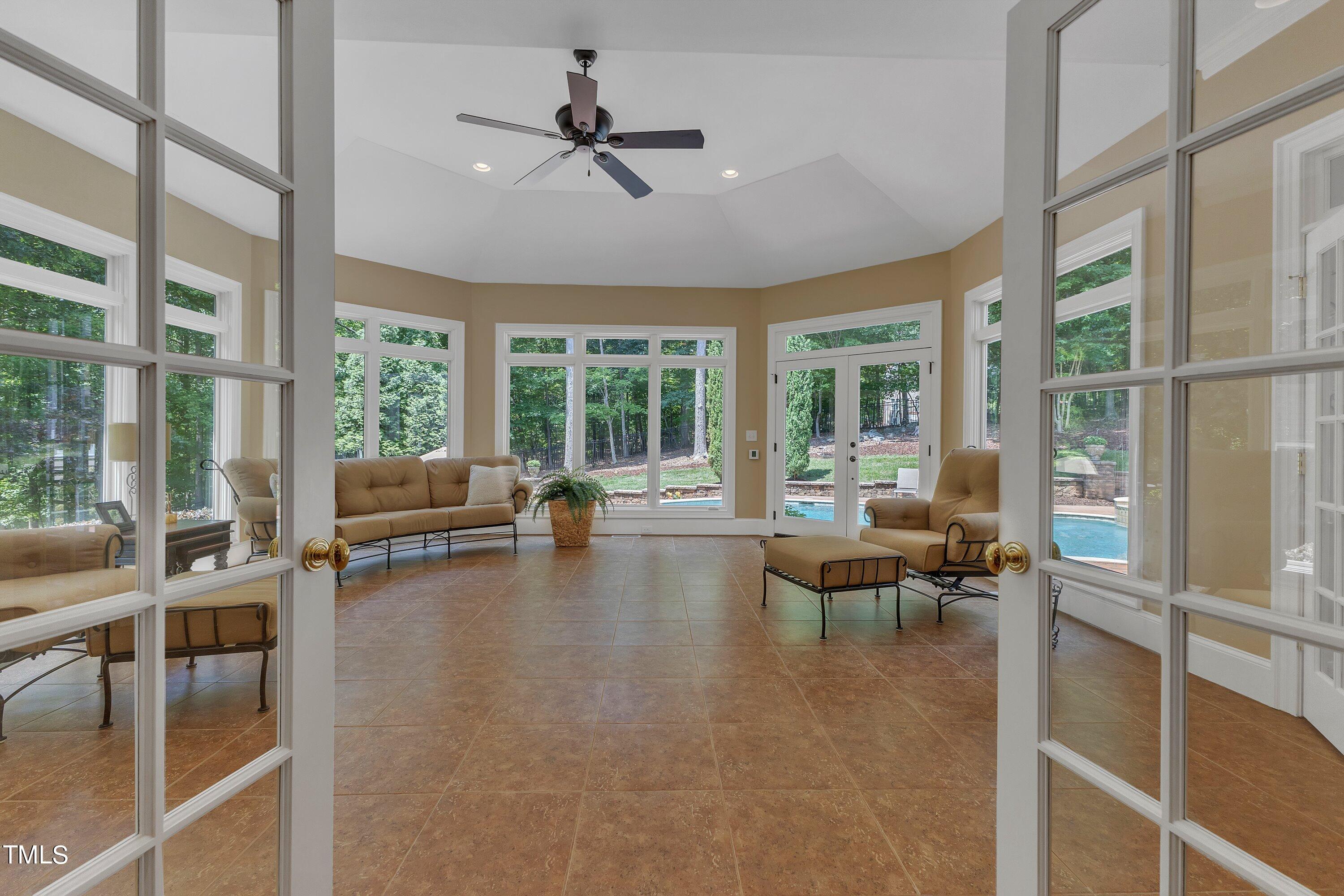 11220 Brass Kettle Road Raleigh, NC 27614 - Photo 27 of 86 a living room with furniture and a large window with garden view