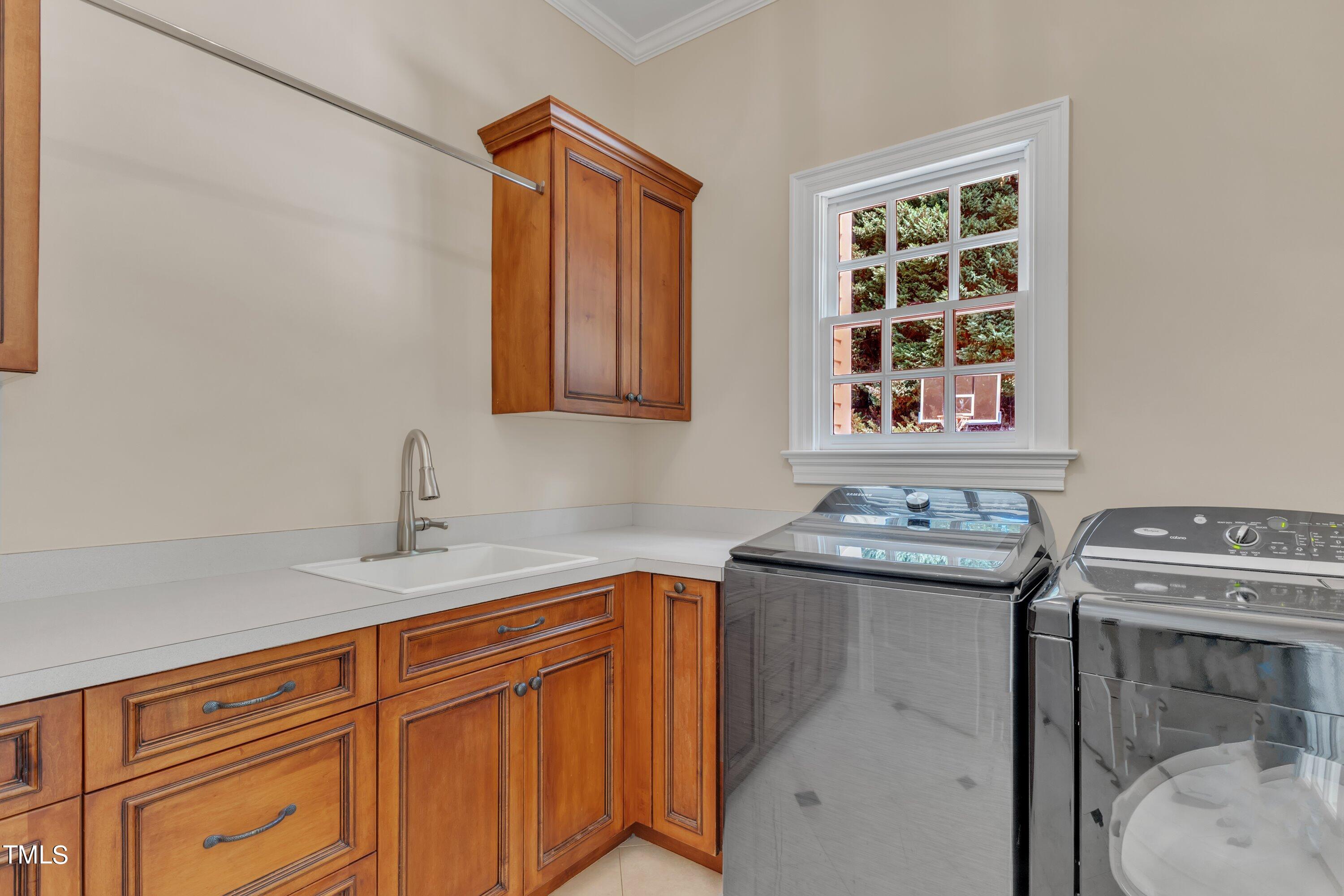11220 Brass Kettle Road Raleigh, NC 27614 - Photo 31 of 86 a utility room with sink dryer and washer