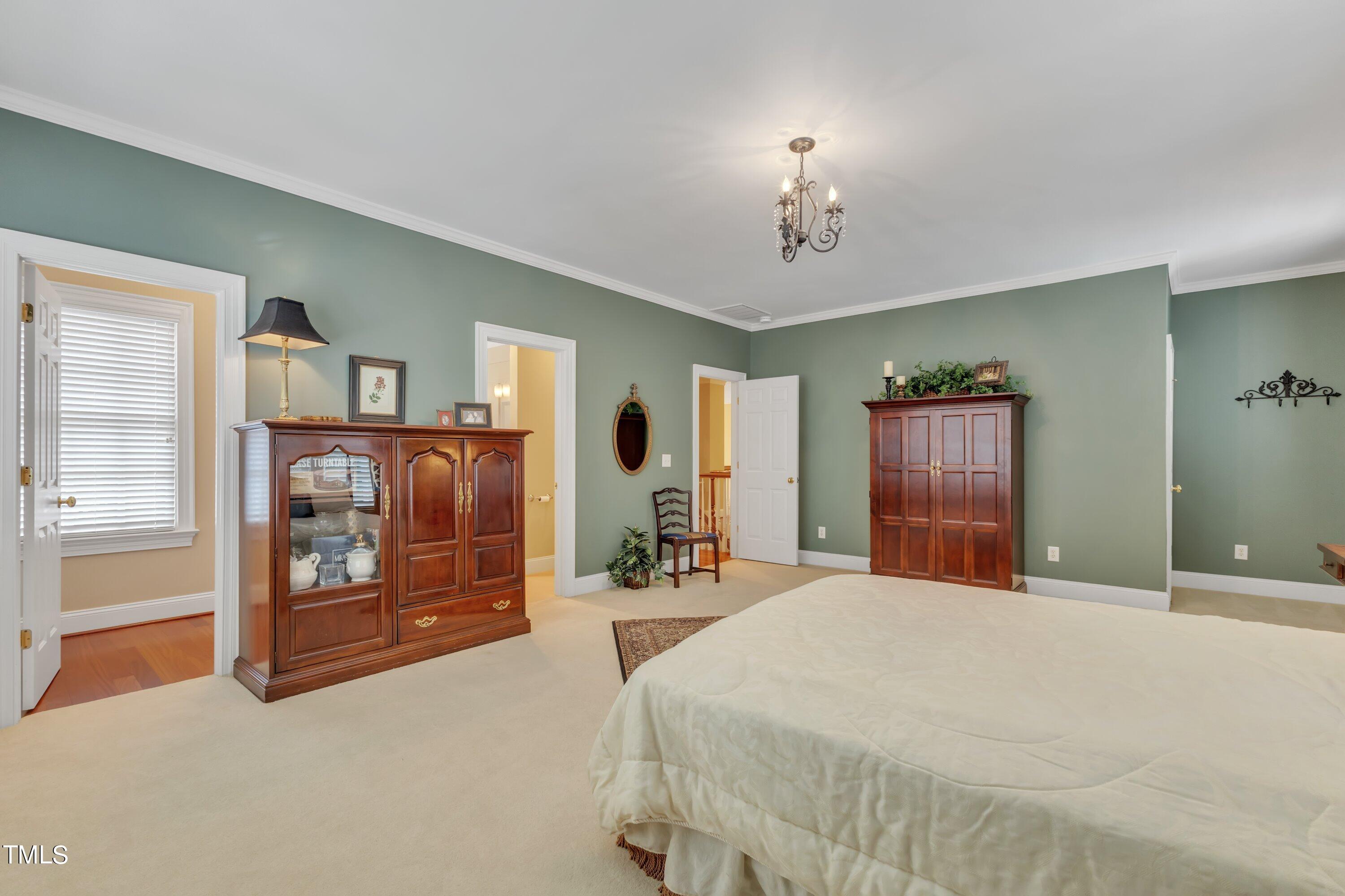 11220 Brass Kettle Road Raleigh, NC 27614 - Photo 36 of 86 a bedroom with a large bed and a dresser